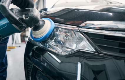 Image of headlight being buffed